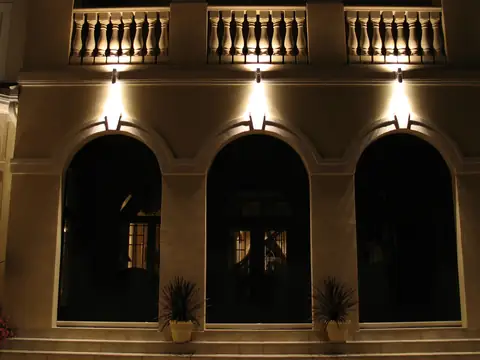Stucco arcade with concealed downlights washing each arch